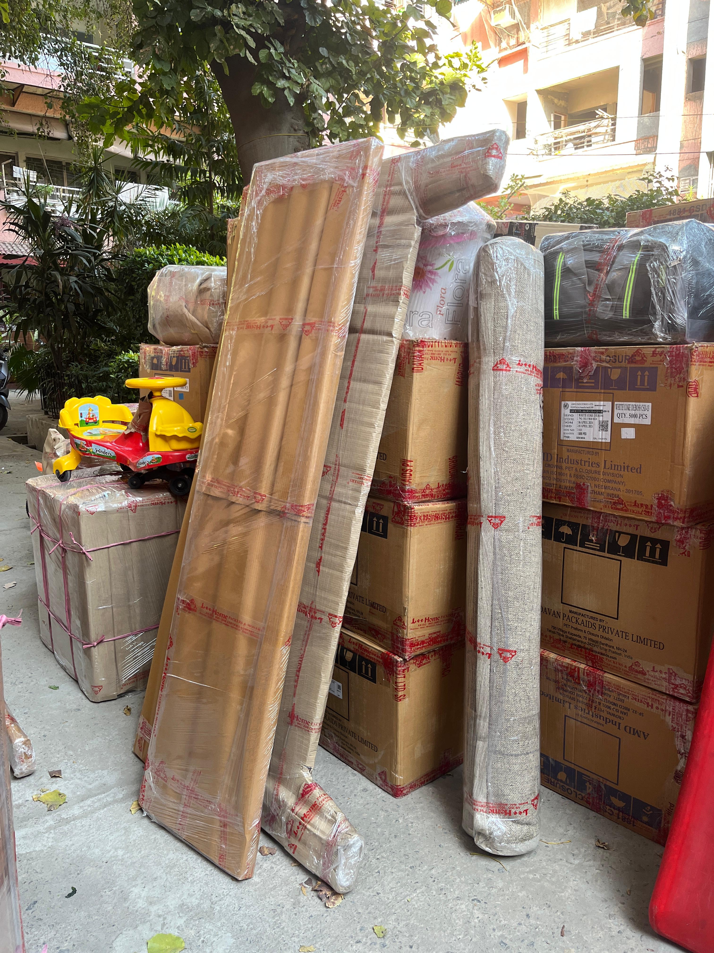 Professional packers and movers in Rohini loading household items into a moving truck